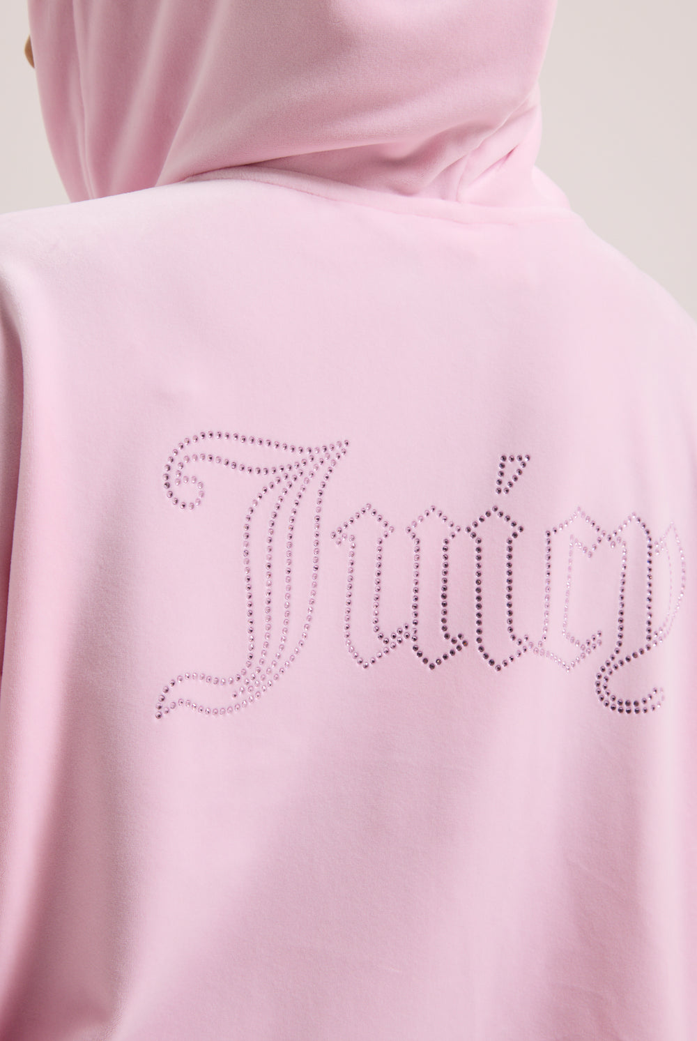 Displays a model wearing the Cherry Blossom 'juicy' branded outline diamanté oversized cropped velour hoodie featuring the juicy branding 