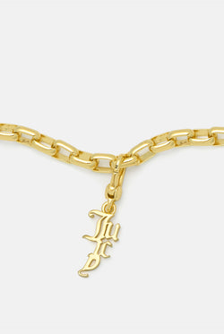 Displays the Gold 'Juicy' branded drop charm 