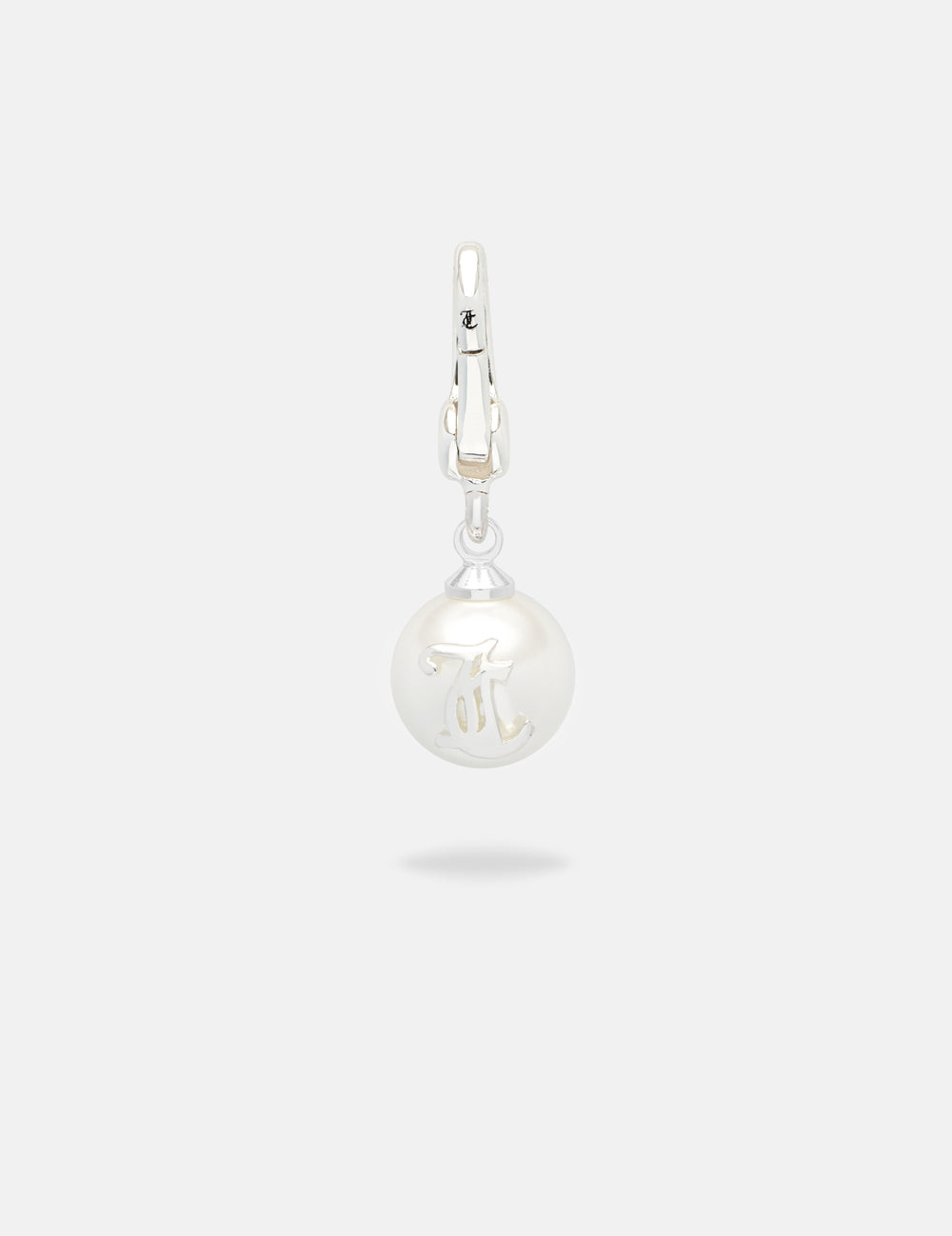 Displays the silver 'Juicy' branded JC pearl charm 