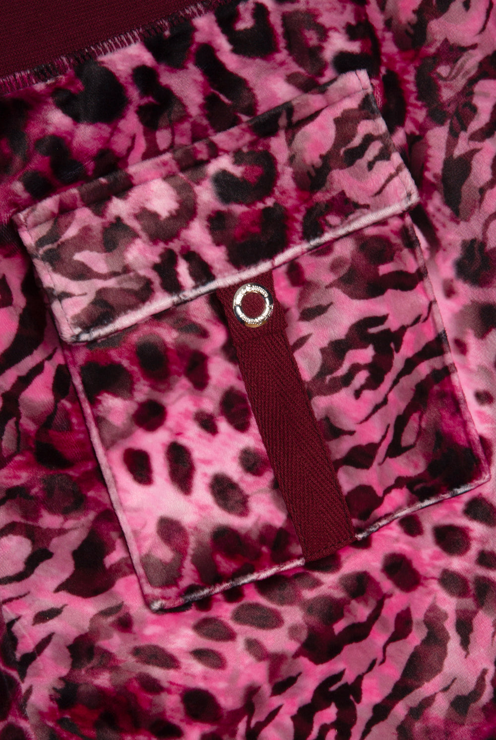 Displays the pink leopard 'Juicy' branded cheetah track bottoms 