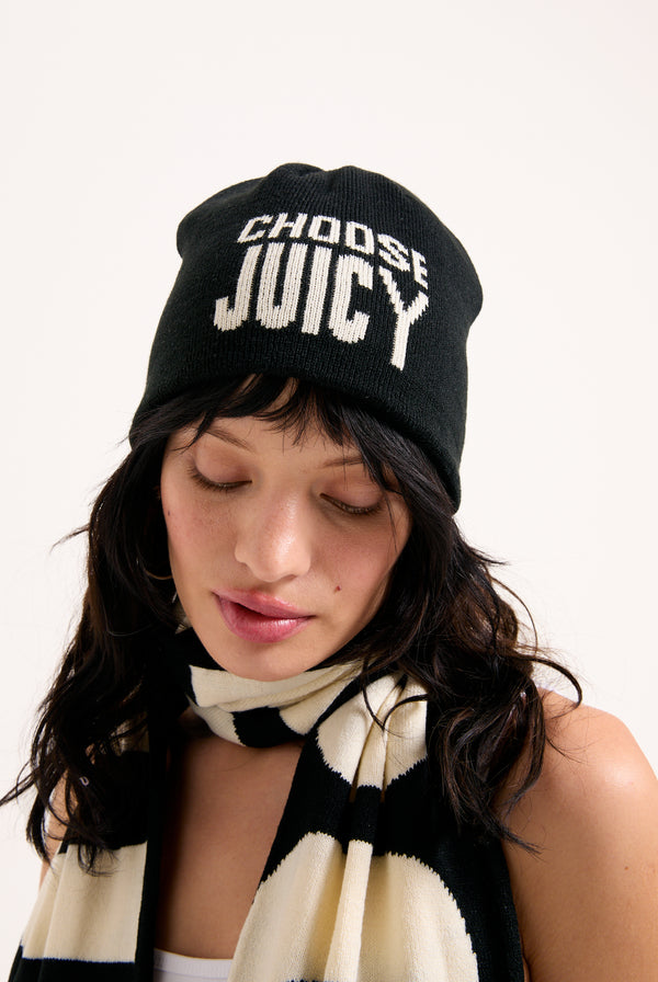 Displays a model wearing the 'Choose Juicy' knitted scarf/beanie included in the set 