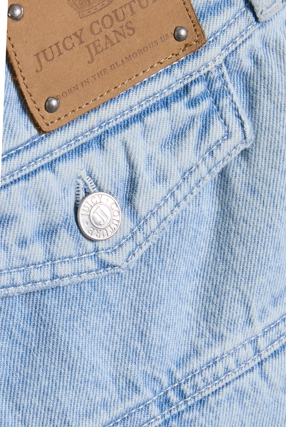 Displays a model wearing the light wash  'juicy' branded denim pleated mini skirt 