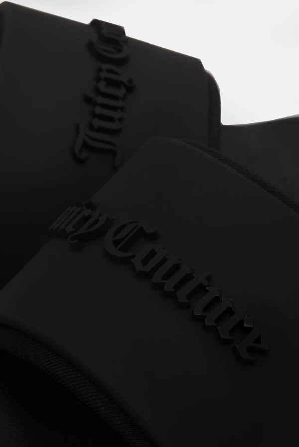 Displays a pair of the Black 'juicy' branded stacked embossed sliders featuring the juicy couture branding
