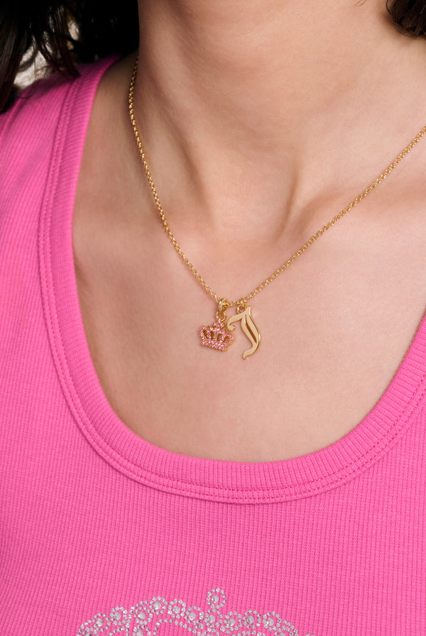Displays a model wearing the Gold tone 'Juicy' crystal motif crown & J charm pendant 