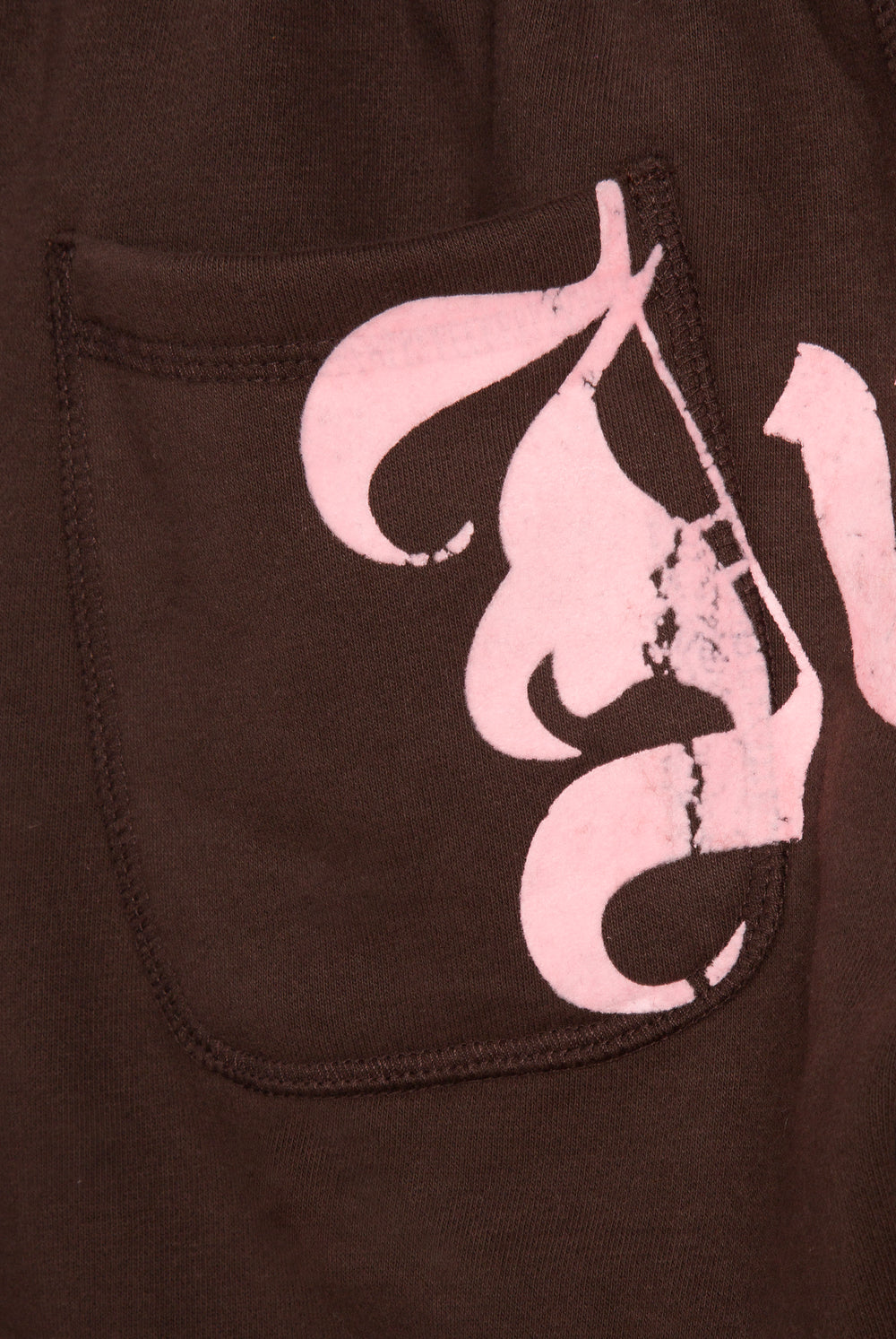 Displays a model wearing the Java 'Juicy' branded relaxed fit flare fleece trackpant featuring the juicy logo