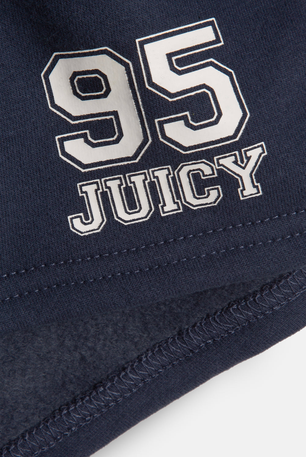 Displays a model wearing the Mood Indigo 'Juicy' branded fleece booty shorts featuring the 95 juicy branding 