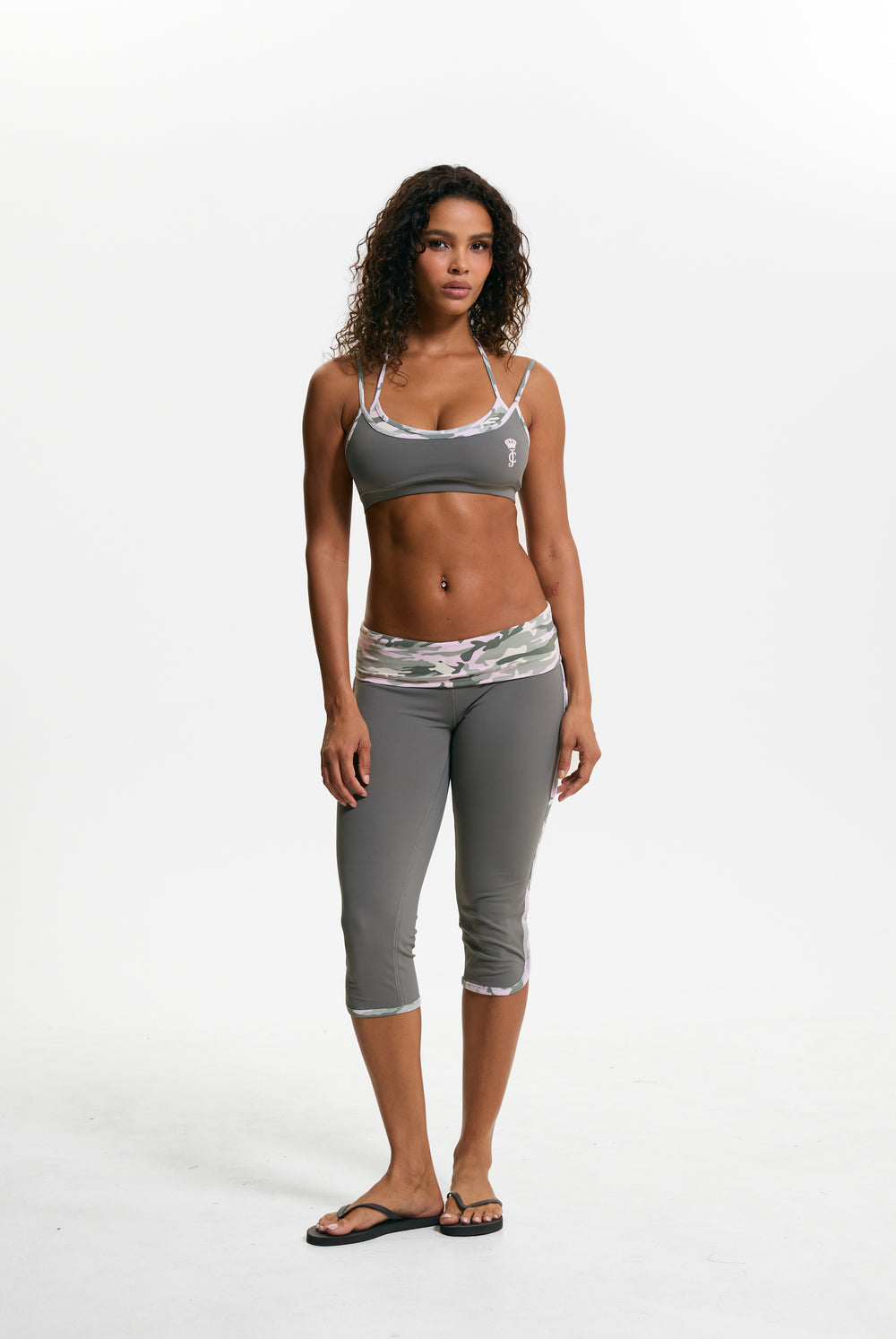 Displays a model wearing the Thyme 'Juicy' branded Sport Contrast Capris