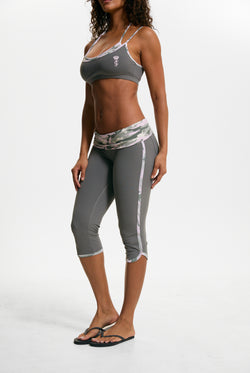 Displays a model wearing the Thyme 'Juicy' branded Sport Contrast Capris