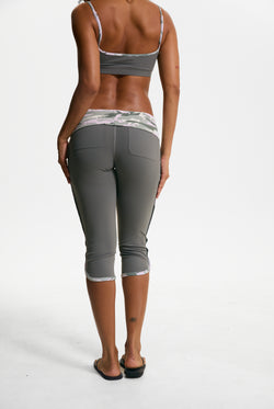 Displays a model wearing the Thyme 'Juicy' branded Sport Contrast Capris