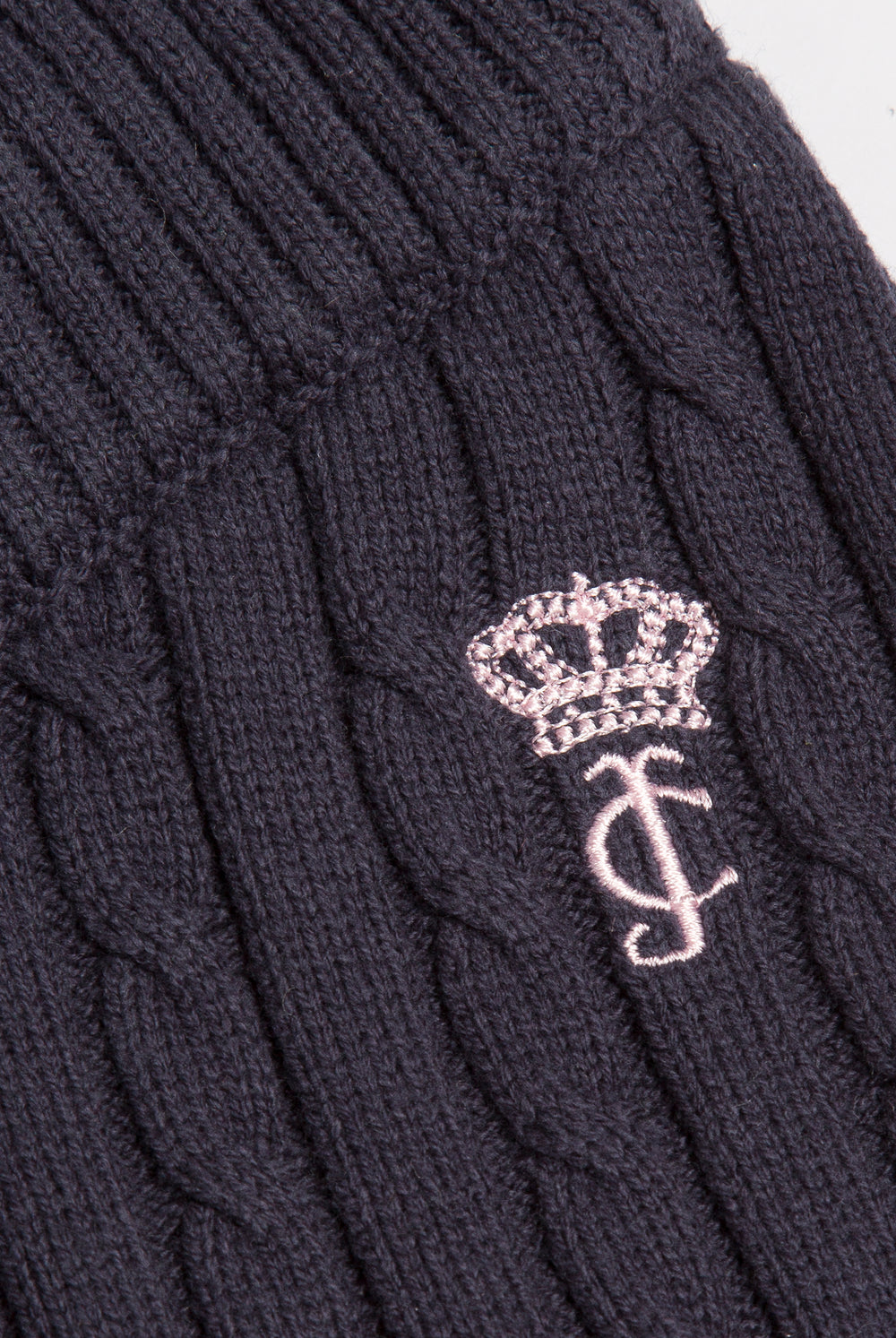 Displays the Night Sky 'Juicy' branded Cable Knit Straight Leg Pants featuring the close up on the juicy branding 