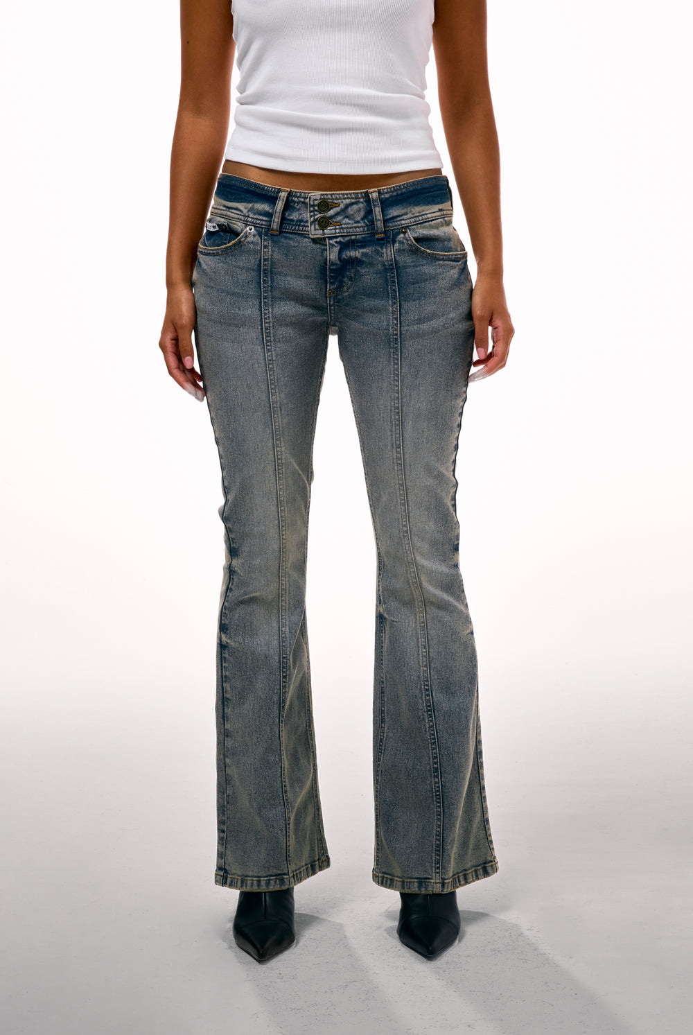 Displays a model wearing the Vintage Wash 'Juicy' branded Low Rise flared embroiled jeans 