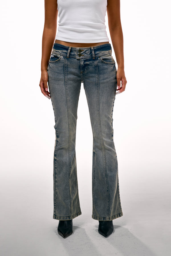 Displays a model wearing the Vintage Wash 'Juicy' branded Low Rise flared embroiled jeans 