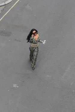 Displays a model wearing the Camo Print 'Juicy' branded washed cotton hoodie 