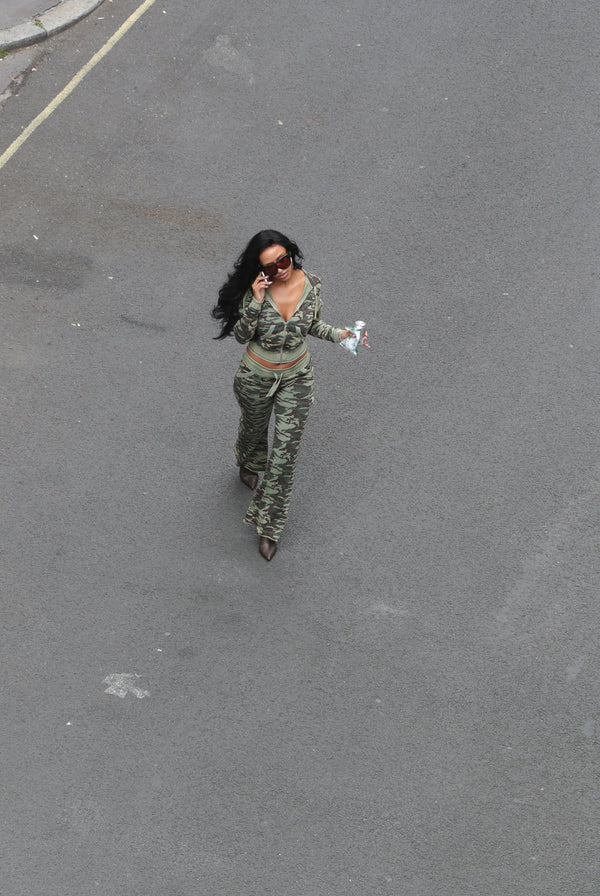 Displays a model wearing the Camo Print 'Juicy' branded washed cotton hoodie 