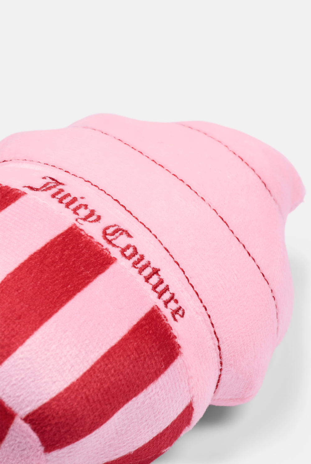 Displays the Red/Pink 'Juicy' branded Cupcake Pet Toy featuring the details on the juicy branding 