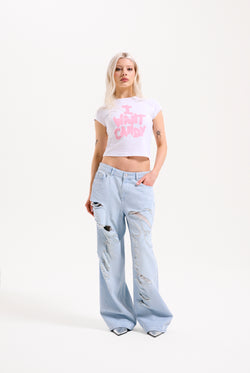 Displays a model wearing the Bleached 'Juicy' branded denim distressed wide leg jeans 
