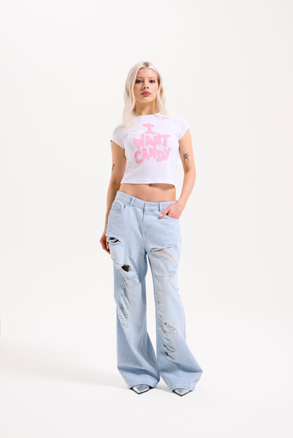 Displays a model wearing the Bleached 'Juicy' branded denim distressed wide leg jeans 