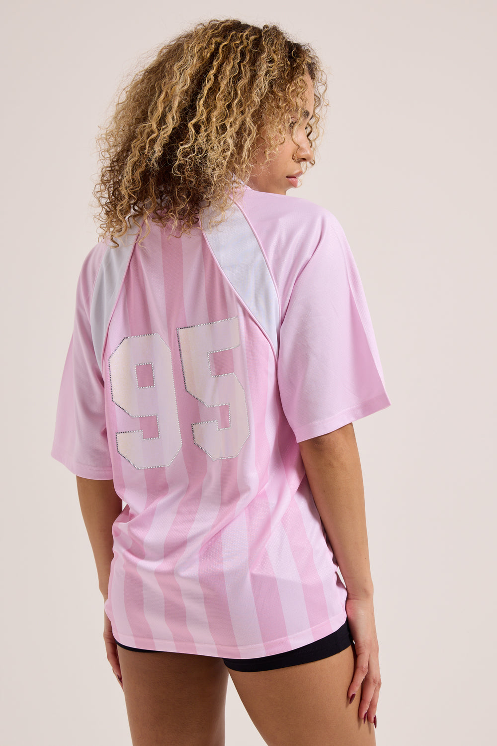 Displays a model wearing the Cherry Blossom 'Juicy' branded football polo shirt