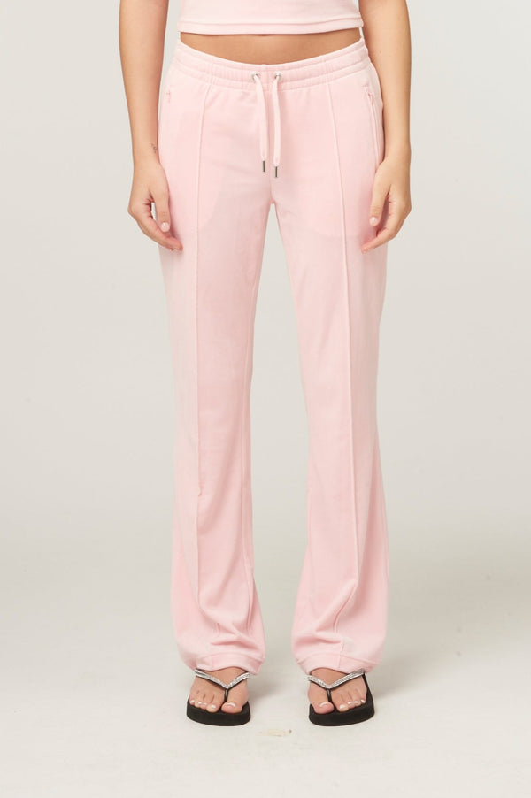 Displays a model wearing the Almond Blossom 'Juicy' branded velour diamanté tracksuit bottom 