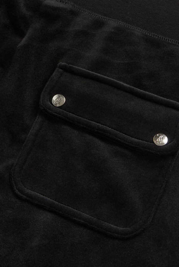 Displays the Black Low rise flare pocket 'Juicy' branded classic velour track pant featuring the pocket 
