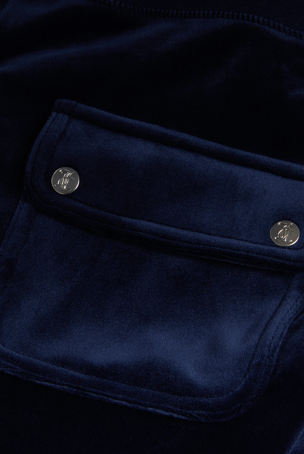 Displays the Night Sky 'Juicy' branded low rise velour track pants featuring a pocket