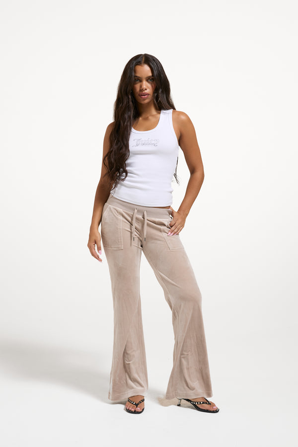 Displays a model wearing the String 'Juicy' branded low rise flare pocket classic velour track pant 