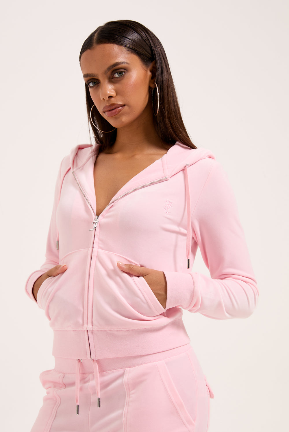Displays a model wearing the Almond Blossom 'Juicy' branded classic velour Robertson hoodie 