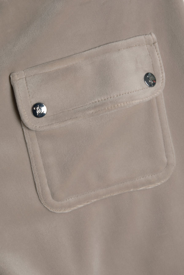 Displays the String 'Juicy' branded low rise flare pocket classic velour track pant featuring the details on the pockets