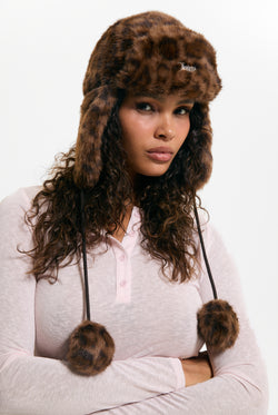 Displays a model wearing the Natural Leopard 'Juicy' branded Long Pile Fur Trapper