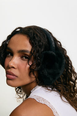 Displays a model wearing the Black 'Juicy' branded Long Fur Heart Shape Ear Muffs