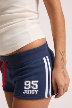 Displays a model wearing the Mood Indigo 'Juicy' branded fleece booty shorts 