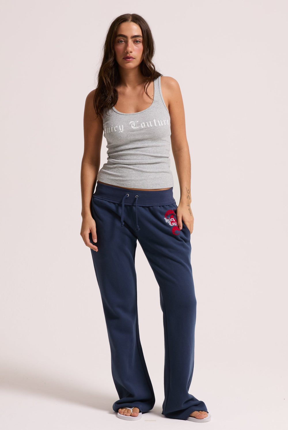 Displays a model wearing the Silver Marl 'Juicy' branded longline ribbed vest 