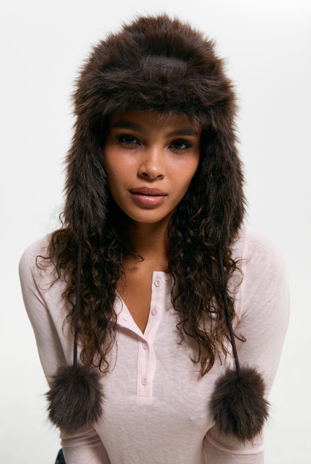 Displays a model wearing the Java 'Juicy' branded Long Pile Trapper Hat