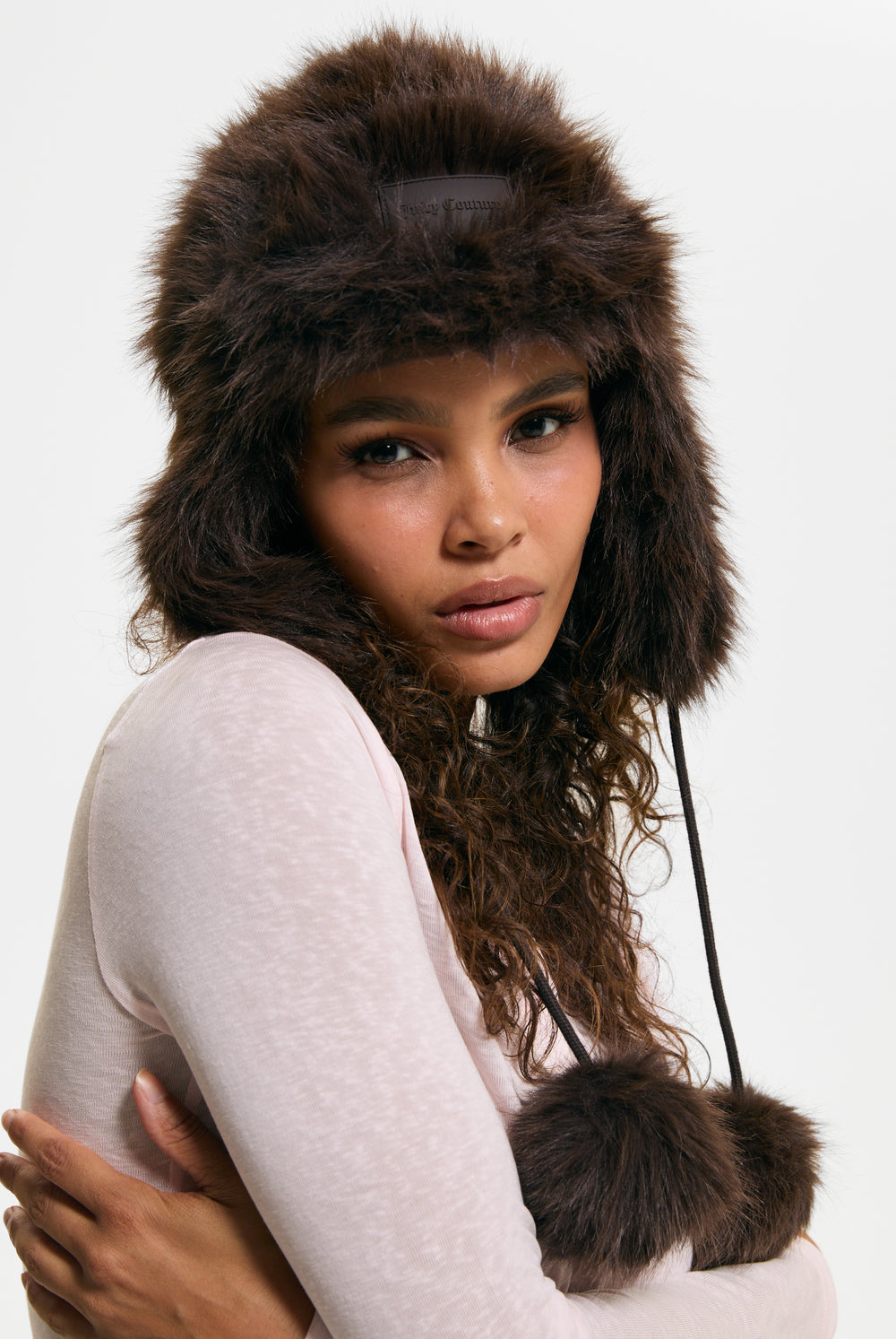 Displays a model wearing the Java 'Juicy' branded Long Pile Trapper Hat