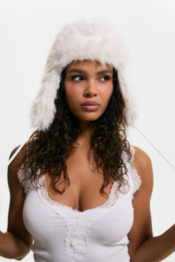Displays a model wearing the Sugar Swizzle 'Juicy' branded Long Pile Trapper Hat
