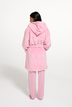 Displays a model wearing the Juicy Pink 'Juicy' branded Plush Crest Robe