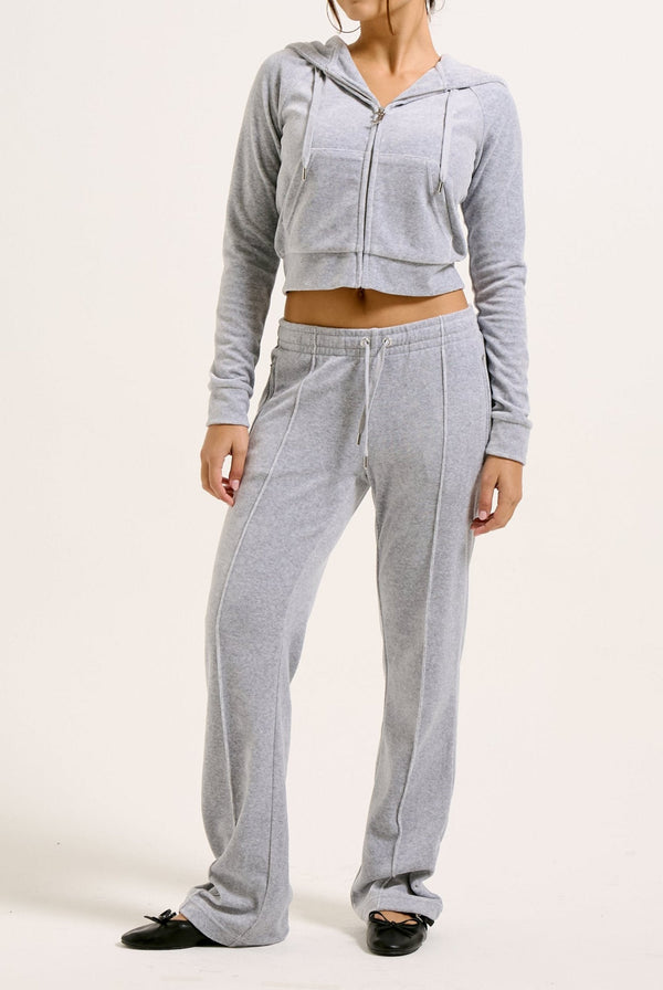 Displays a model wearing the Silver Marl Diamanté 'Juicy' branded cotton velour tracksuit bottom  