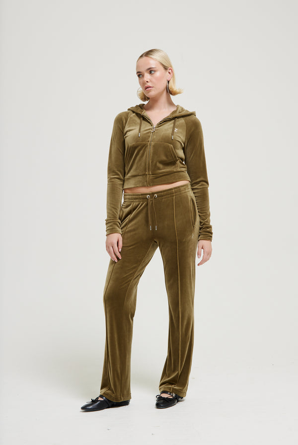 Displays a model wearing the Dark Olive 'Juicy' branded velour diamanté tracksuit bottom