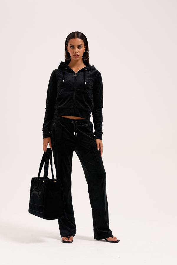 Displays a model wearing the Black 'Juicy' branded outline diamanté velour zip-through hoodie 