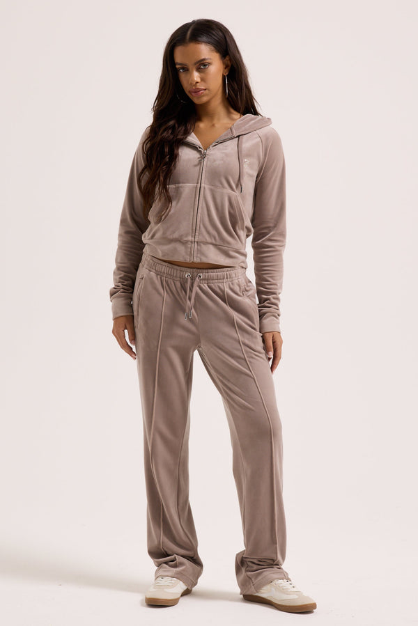 Displays a model wearing the jungle outline 'juicy' branded velour diamanté tracksuit bottom