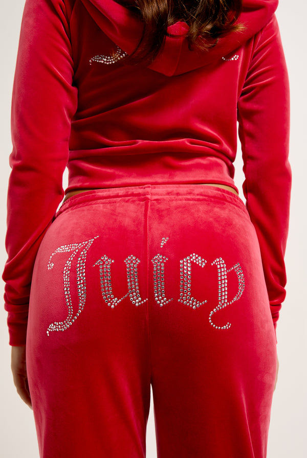 Displays the Astor Red Velour 'Juicy' branded Diamanté tracksuit bottoms 