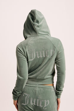 Displays a model wearing the Chinois Green 'Juicy' branded diamanté velour zip-through hoodie 