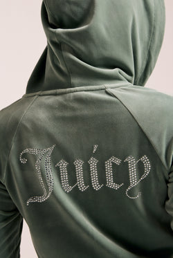 Displays a model wearing the Chinois Green 'Juicy' branded diamanté velour zip-through hoodie featuring the juicy branding 