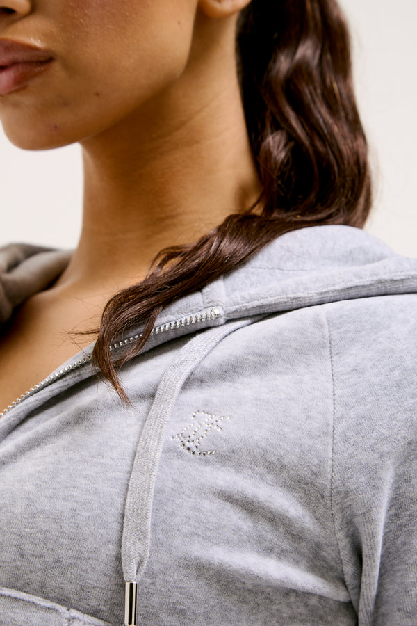 Displays a model wearing the Silver Marl Diamanté 'Juicy' branded cotton velour zip-through hoodie
