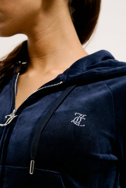 Displays a model wearing the Night Sky Diamanté 'Juicy' branded velour zip-through hoodie  