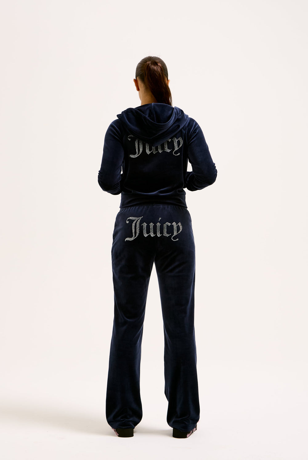 Displays a model wearing the Night Sky Diamanté 'Juicy' branded velour zip-through hoodie  