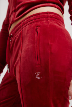 Displays the Red Dahlia 'Juicy' branded velour diamanté tracksuit bottom
