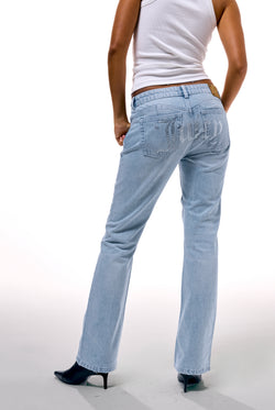 Displays a model wearing the Light Wash 'Juicy' branded Diamanté bootcut jeans  
