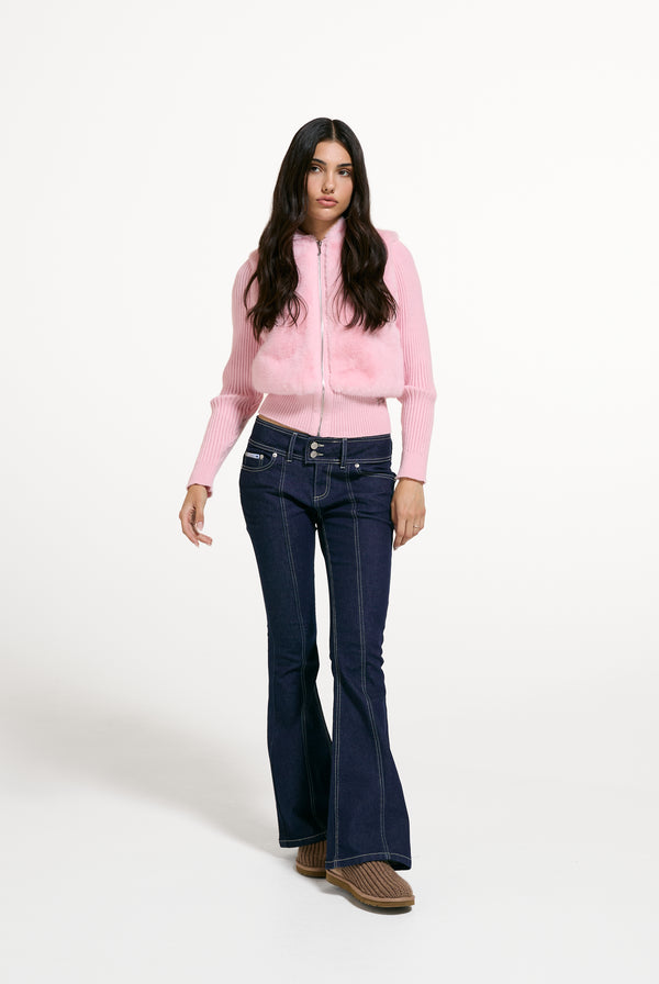 Displays a model wearing the Almond Blossom 'Juicy' branded Faux Fur Knitted Jacket