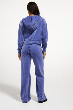 Displays a model wearing the Greyblue 'Juicy' branded Old Gothic Diamante OG Straight Leg Trackpant